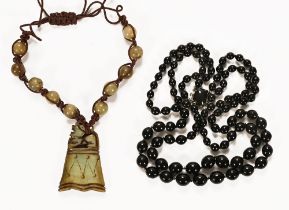 A Chinese hardstone necklace, together with a double strand bead necklace.