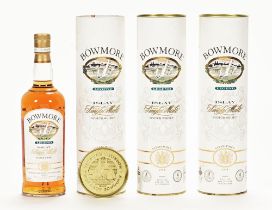 A collection of three bottles of Bowmore Legend Islay single malt Scotch whisky.