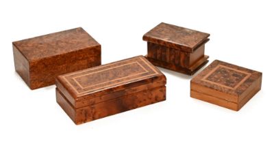 A collection of four amboyna and specimen wood boxes, various sizes. Largest width 26 cm.