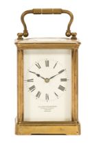 An early 20th century brass and glass panelled carriage clock,