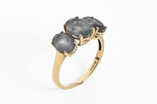 A 9 ct gold dress ring with smoky stones. Size Q. Gross weight 2.6 grams.