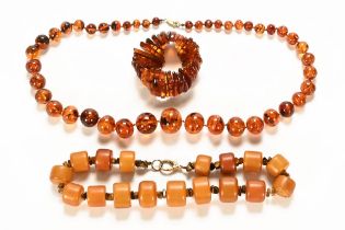 Two large amber necklaces and a similar bracelet.