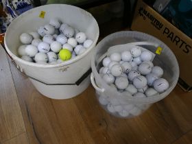 Two tubs of golf balls