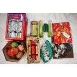 Box of Christmas decorations including crackers and baubles