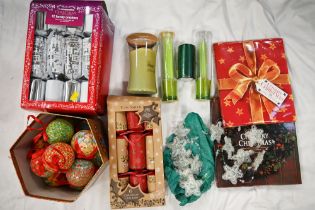 Box of Christmas decorations including crackers and baubles