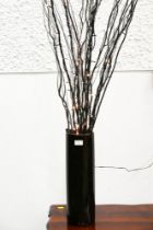 Vase with lit twigs,