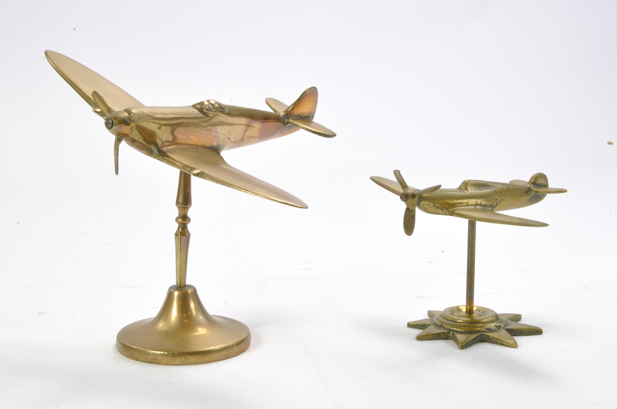 A duo of Brass Desk Brass Model Aircraft comprising a Spitfire (larger model) plus Hurricane.