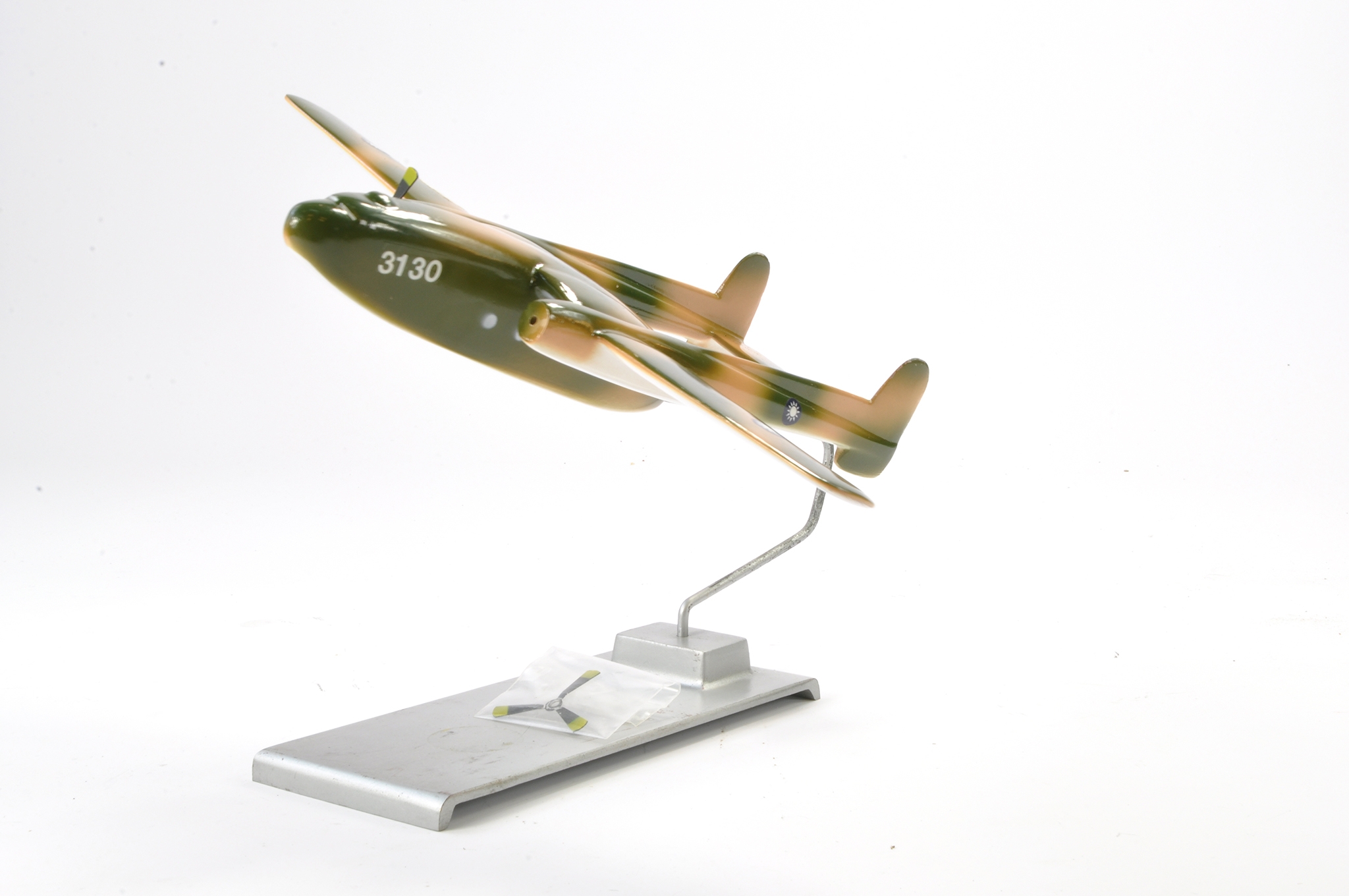 An unusual metal model aircraft (on stand) of what appears could be the P-38 Lightning. Some signs