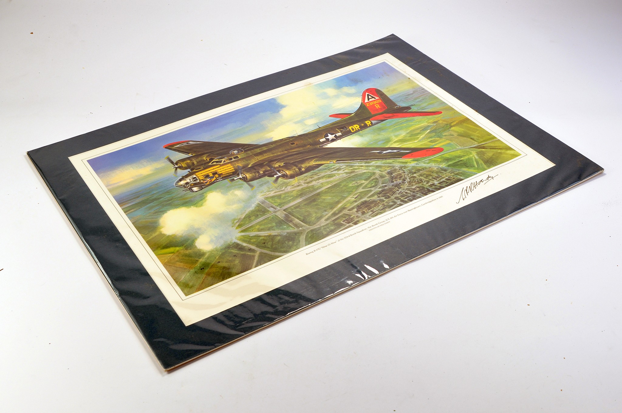 Mounted limited edition aircraft print of a Boeing 17G over Bassinghamm Cambs in 1945. Signed by