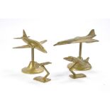A group of four desk brass model aircraft comprising Concorde, Hawk, Harrier and one other.