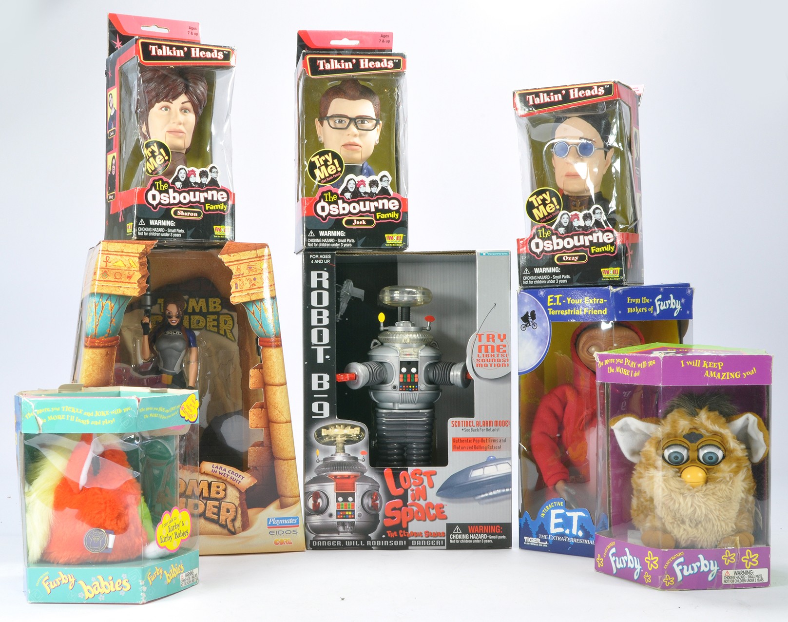 An assortment of electronic toys including Talkin Heads Osborne family, Furby duo, Lost in Space