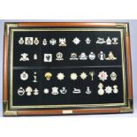 An attractive framed display montage of military badges from the 'military badge collection'.