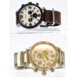 A duo of Wrist Watches to include Fossil Nate JR1390 brown leather chronograph sports plus a Nixon