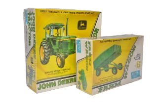 Ertl 1/25 plastic model kit comprising John Deere 4430 Tractor plus trailer. Sealed with wrapper.