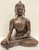 A modern bronze figure of the Shakyamuni or Gautama Buddha seated in lotus position 31 cm high