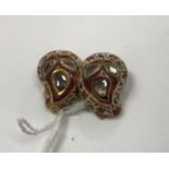 A pair of yellow metal and enamel decorated diamond set earrings of leaf design,