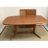 A Danish teak rounded rectangular extending dining table in the manner of Niels Koefoed on end