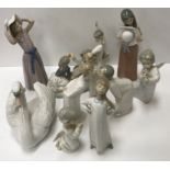 A collection of twelve various Lladro figures including "Boy and girl on a seesaw" 23 cm long x 19.