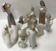 A collection of twelve various Lladro figures including "Boy and girl on a seesaw" 23 cm long x 19.