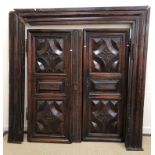A pair of 19th Century French walnut doors with panelled and fleur de lys decoration together with