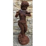 A cast metal figure of a putti with butterfly, with rust style patination,