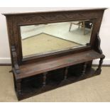 A carved oak part glazed two door cupboard in the Gothic style,