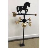 A painted cast iron weather vane with horse surmount