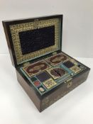 An early 19th Century rosewood and brass inlaid sewing box with tooled and gilded leather covered
