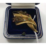 A mid 20th Century 18 carat gold brooch of spray form, set with 2 small diamonds , 2 sapphires,