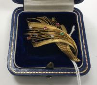 A mid 20th Century 18 carat gold brooch of spray form, set with 2 small diamonds , 2 sapphires,