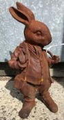 A cast metal figure of "Mr Rabbit" with rust style patination,