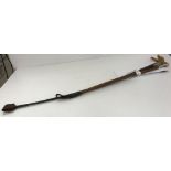 A vintage riding crop with plaited shaft and white metal ferrule,