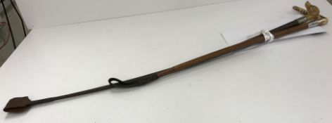 A vintage riding crop with plaited shaft and white metal ferrule,