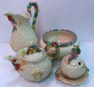 A collection of five pieces of Clarice Cliff Newport Pottery Celtic harvestware including baluster