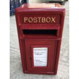 A modern reproduction postbox in red,