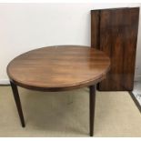 A mid 20th Century rosewood circular extending dining table,