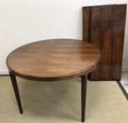 A mid 20th Century rosewood circular extending dining table,
