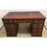 A modern reproduction mahogany veneered double pedestal desk with tooled and gilded insert top 137