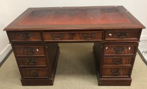 A modern reproduction mahogany veneered double pedestal desk with tooled and gilded insert top 137