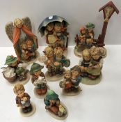 A collection of ten various Goebal Hummel figures including "Heavenly Protection", "Cheeky Fellow",