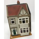 A late 20th Century dolls house with fitted interior together with a further late 20th Century