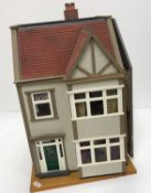 A late 20th Century dolls house with fitted interior together with a further late 20th Century