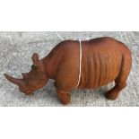 A cast metal figure of a rhinoceros, with rust style patination,