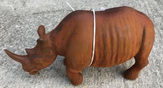 A cast metal figure of a rhinoceros, with rust style patination,