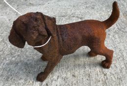 Two cast metal figures of puppies, with rust style patination,