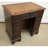 A 20th Century mahogany kneehole desk in the George III manner,