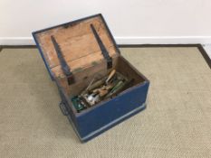 A blue painted trunk with rising lid containing various tools to include G clamps, plane, saws,