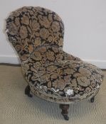 A Victorian nursing/bedroom chair with shaped back raised on ringed and turned front legs to brass
