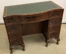 A mahogany serpentine fronted kneehole desk in the George III style,
