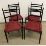 A set of four circa 1960 Ernest Gomme G Plan ebonised framed dining chairs with upholstered seats